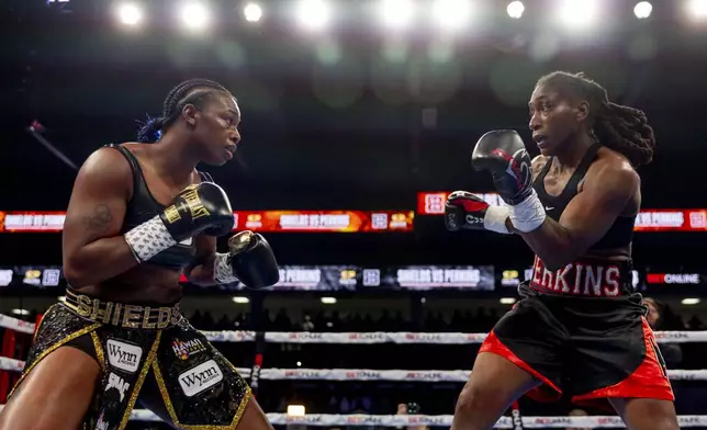 Claressa Shields, left, fights with Danielle Perkins during the undisputed heavyweight title match on Sunday, Feb. 2, 2025 at Dort Financial Center in Flint. (Jake May/The Flint Journal via AP)
