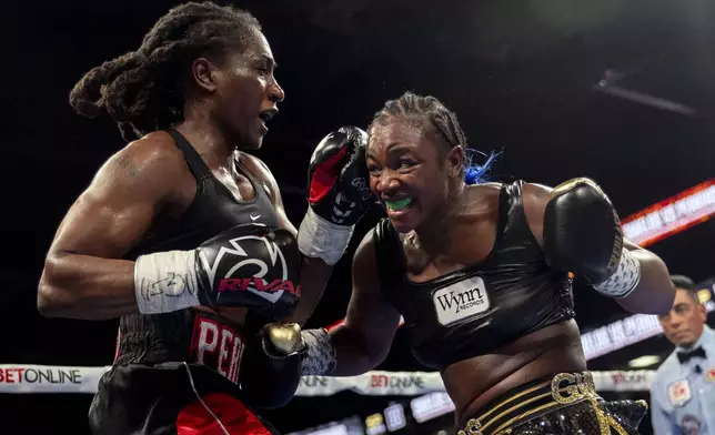 Claressa Shields, right, exchanges punches with Danielle Perkins during the undisputed heavyweight title match on Sunday, Feb. 2, 2025 at Dort Financial Center in Flint. (Jake May/The Flint Journal via AP)