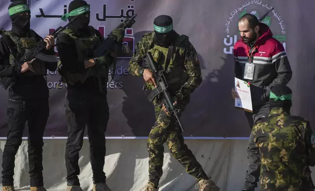 Israeli Yarden Bibas, 34, who has been held hostage by Hamas in Gaza since October 7, 2023, is escorted by Hamas fighters before being handed over to the Red Cross in Khan Younis, southern Gaza Strip, Saturday Feb. 1, 2025. Photo/Abdel Kareem)