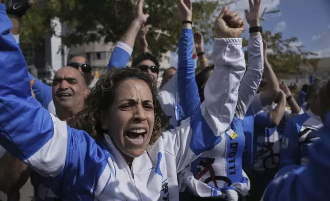 Cycling friends of Ofer Kalderon celebrate his release as part of a ceasefire in the Gaza Strip, at Sheba medical Center in Ramat Gan, Saturday Feb. 1, 2025. (AP Photo/Maya Alleruzzo)