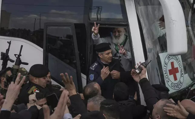 Palestinian prisoners as greeted as they exit a Red Cross bus after being released from Israeli prison following a ceasefire agreement between Israel and Hamas, in the West Bank city of Ramallah, Saturday Feb. 1, 2025. (AP Photo/Mahmoud Illean)
