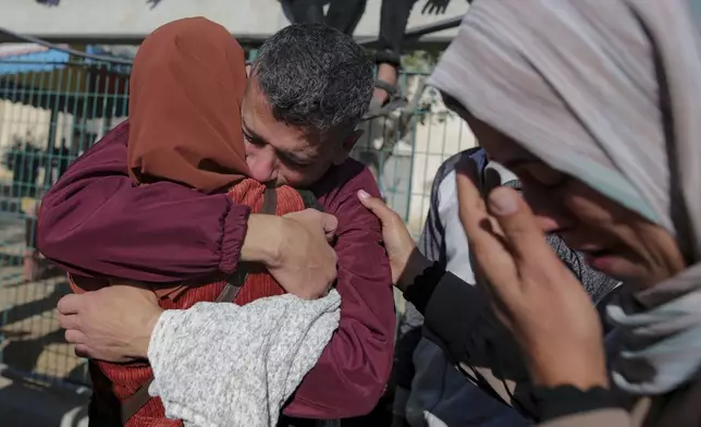 A freed Palestinian prisoner hugs a relative as he arrives in the Gaza Strip after being released from an Israeli prison following a ceasefire agreement between Hamas and Israel in Khan Younis, Saturday, Feb. 1, 2025. (AP Photo/Jehad Alshrafi)