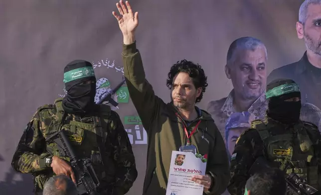Israeli Ofer Kalderon who has been held hostage by Hamas in Gaza since October 7, 2023, waves before being handed over to the Red Cross by Hamas fighters in Khan Younis, southern Gaza Strip, Saturday Feb. 1, 2025. Photo/Abdel Kareem)