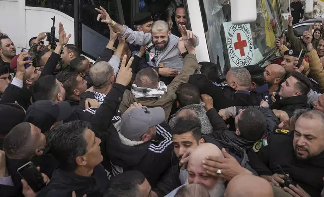 Palestinian prisoners as greeted as they exit a Red Cross bus after being released from Israeli prison following a ceasefire agreement between Israel and Hamas, in the West Bank city of Ramallah, Saturday Feb. 1, 2025. (AP Photo/Mahmoud Illean)