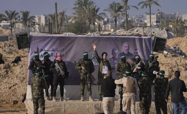 Israeli Ofer Kalderon who has been held hostage by Hamas in Gaza since October 7, 2023, waves before being handed over to the Red Cross by Hamas fighters in Khan Younis, southern Gaza Strip, Saturday Feb. 1, 2025. Photo/Abdel Kareem)