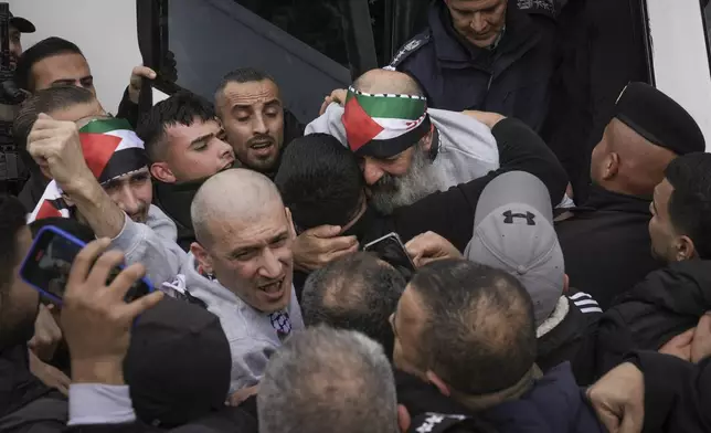 Palestinian prisoners as greeted as they exit a Red Cross bus after being released from Israeli prison following a ceasefire agreement between Israel and Hamas, in the West Bank city of Ramallah, Saturday Feb. 1, 2025. (AP Photo/Mahmoud Illean)