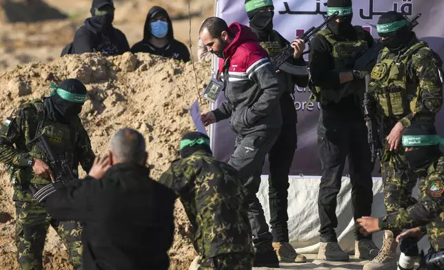 Israeli Yarden Bibas, 34, who has been held hostage by Hamas in Gaza since October 7, 2023, is escorted by Hamas fighters before being handed over to the Red Cross in Khan Younis, southern Gaza Strip, Saturday Feb. 1, 2025. Photo/Abdel Kareem)
