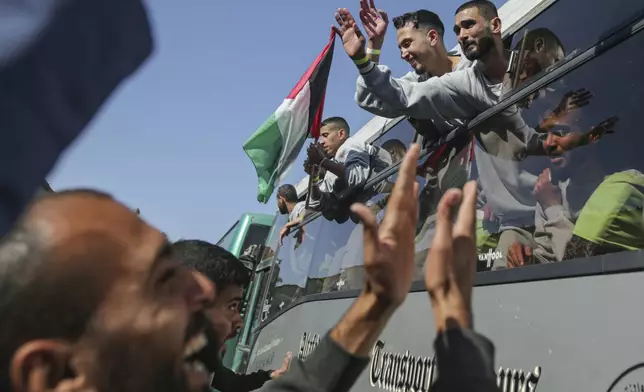 Freed Palestinian prisoners are greeted by a crowd as they arrive in the Gaza Strip after being released from an Israeli prison following a ceasefire agreement between Hamas and Israel in Khan Younis, Saturday, Feb. 1, 2025. (AP Photo/Jehad Alshrafi)