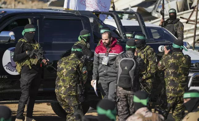 Israeli Yarden Bibas, 34, who has been held hostage by Hamas in Gaza since October 7, 2023, is escorted by Hamas fighters before being handed over to the Red Cross in Khan Younis, southern Gaza Strip, Saturday Feb. 1, 2025. Photo/Abdel Kareem)