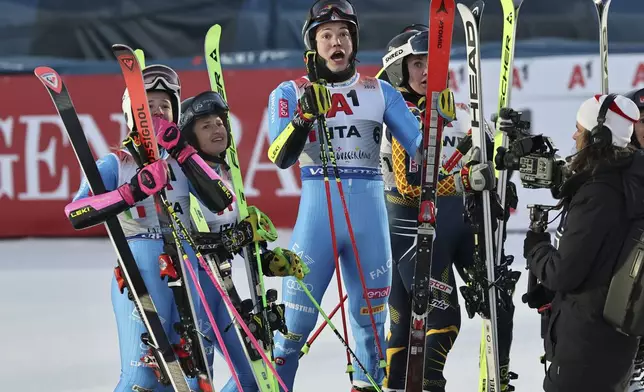 Italy team react during an alpine ski, World Championship team parallel event, in Saalbach-Hinterglemm, Austria, Tuesday, Feb. 4, 2025. (AP Photo/Marco Trovati)