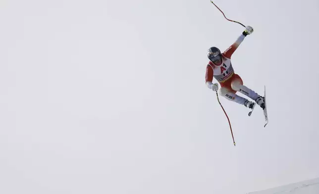 Switzerland's Franjo von Allmen is airborne during a men's downhill race, at the Alpine Ski World Championships, in Saalbach-Hinterglemm, Austria, Sunday, Feb. 9, 2025. (AP Photo/Gabriele Facciotti)