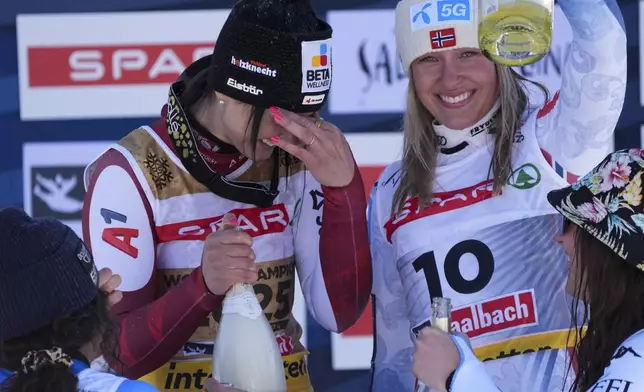 Austria's Stephanie Venier, second from left, winner of a women's Super-G, celebrates on the podium with second-placed Italy's Federica Brignone, bottom left, and joint third-placed Norway's Kajsa Vickhoff Lie, second from right, and United States' Lauren Macuga, at the Alpine Ski World Championships, in Saalbach-Hinterglemm, Austria, Thursday, Feb. 6, 2025. (AP Photo/Giovanni Auletta)