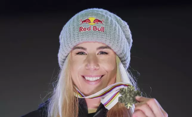 Czech Republic's Ester Ledecka shows her bronze medal for a women's downhill race, at the Alpine Ski World Championships, in Saalbach-Hinterglemm, Austria, Saturday, Feb. 8, 2025. (AP Photo/Giovanni Auletta)