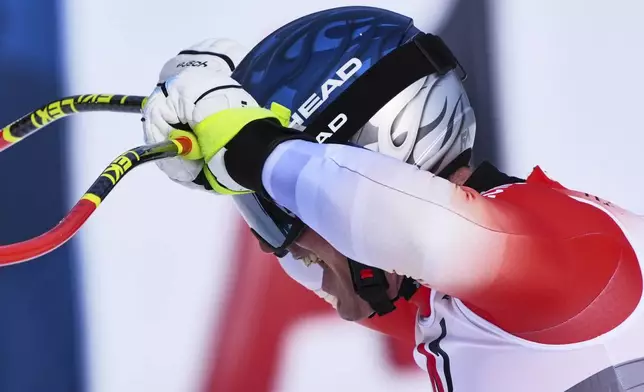 Switzerland's Franjo von Allmen celebrates at the finish area of a men's downhill race, at the Alpine Ski World Championships, in Saalbach-Hinterglemm, Austria, Sunday, Feb. 9, 2025. (AP Photo/Giovanni Auletta)