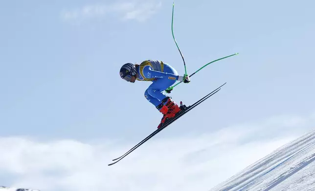 Italy's Sofia Goggia is airborne during a women's downhill race, at the Alpine Ski World Championships, in Saalbach-Hinterglemm, Austria, Saturday, Feb. 8, 2025. (AP Photo/Gabriele Facciotti)
