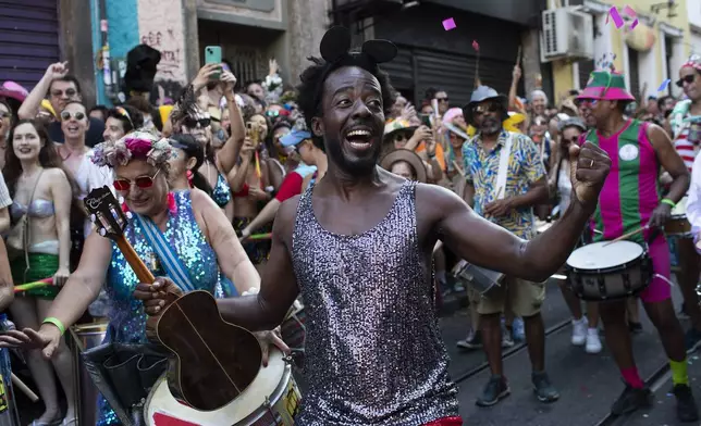 Musicians parade in the "Ceu na Terra" or "Heaven on Earth" pre-Carnival street party, in Rio de Janeiro, Saturday, Feb. 22, 2025. (AP Photo/Bruna Prado)