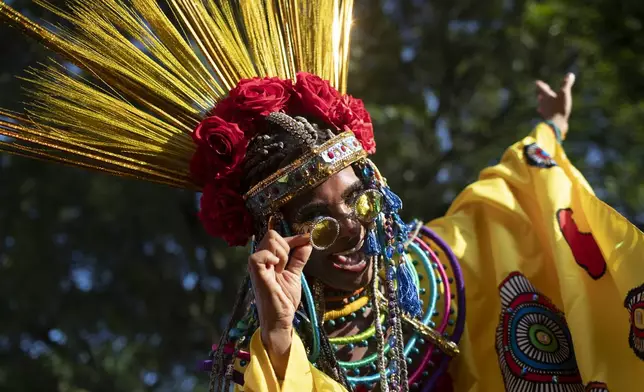 A reveler strikes a pose during the "Ceu na Terra" or "Heaven on Earth" pre-Carnival street party, in Rio de Janeiro, Saturday, Feb. 22, 2025. (AP Photo/Bruna Prado)