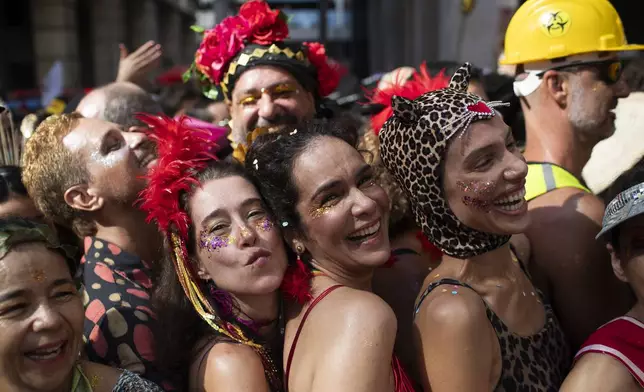 Revelers attend the "Cordao do Boitata" street pre-carnival party in Rio de Janeiro, Sunday, Feb. 23, 2025. (AP Photo/Bruna Prado)