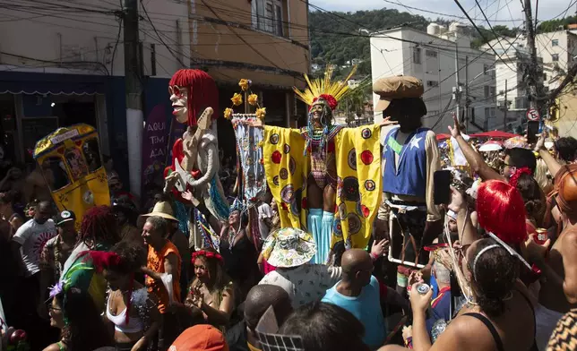 Raquel Poti, center back, performs on stilts during the "Ceu na Terra" or "Heaven on Earth" pre-Carnival street party, in Rio de Janeiro, Saturday, Feb. 22, 2025. (AP Photo/Bruna Prado)