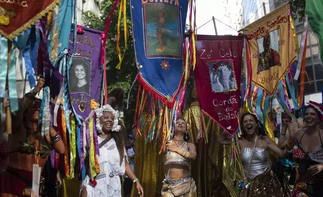 Revelers dance at the "Cordao do Boitata" street pre-carnival party in Rio de Janeiro, Sunday, Feb. 23, 2025. (AP Photo/Bruna Prado)