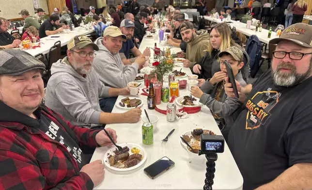 Diners enjoy a wild game dinner that included boar, bobcat and coyote in Pine Grove, Pa.,, on Saturday, Feb. 15, 2025. (AP Photo/Mark Scolforo)