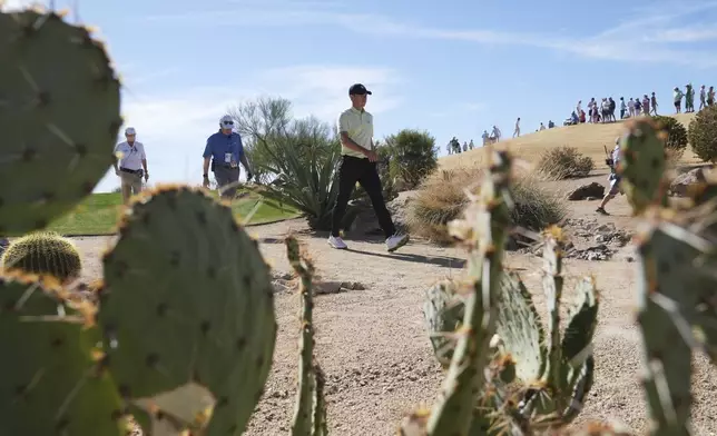 Jordan Spieth walks through the desert to get to the fourth green during the third round of the Phoenix Open golf tournament at TPC Scottsdale, Saturday, Feb. 8, 2025, in Scottsdale, Ariz. (AP Photo/Ross D. Franklin)