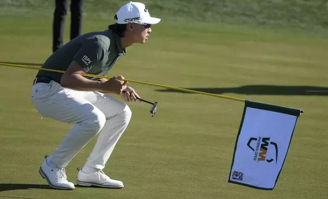 Min Woo Lee, of Australia, lines up a putt on the first hole during the third round of the Phoenix Open golf tournament at TPC Scottsdale Saturday, Feb. 8, 2025, in Scottsdale, Ariz. (AP Photo/Ross D. Franklin)