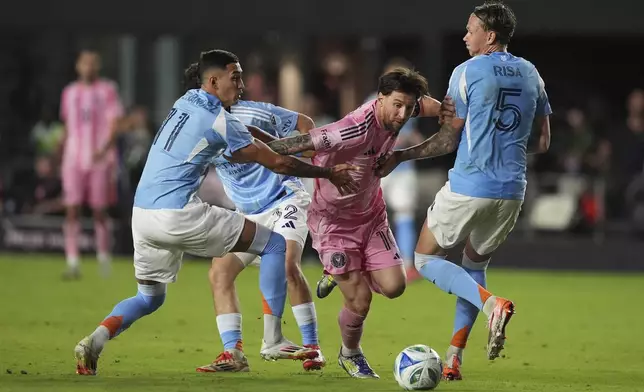Inter Miami forward Lionel Messi comes under pressure from New York City FC defender Birk Risa (5) and forward Julian Fernandez as they battle during the second half of an MLS soccer match, Saturday, Feb. 22, 2025, in Fort Lauderdale, Fla. (AP Photo/Rebecca Blackwell)