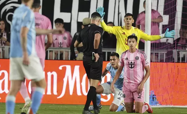 A referee pulls out a red card for Inter Miami midfielder Tomas Aviles (6) as New York City FC forward Alonso Martinez (16) and Inter Miami goalkeeper Oscar Ustari (19) look on during the first half of an MLS soccer match, Saturday, Feb. 22, 2025, in Fort Lauderdale, Fla. (AP Photo/Rebecca Blackwell)