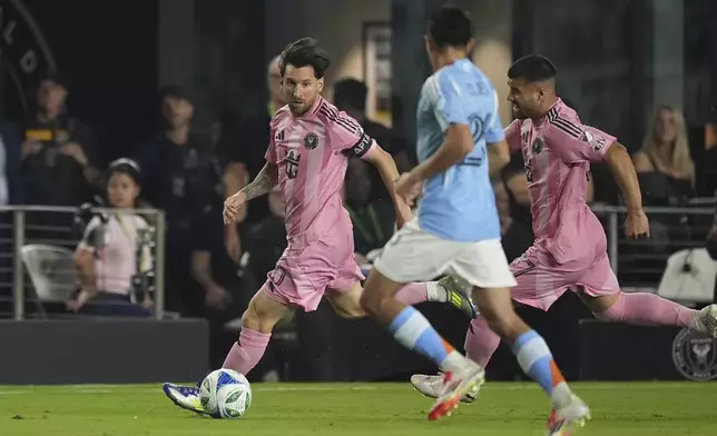 Inter Miami forward Lionel Messi (10) carries the ball as New York City FC forward Agustin Ojeda (26) looks to defend during the first half of an MLS soccer match, Saturday, Feb. 22, 2025, in Fort Lauderdale, Fla. (AP Photo/Rebecca Blackwell)