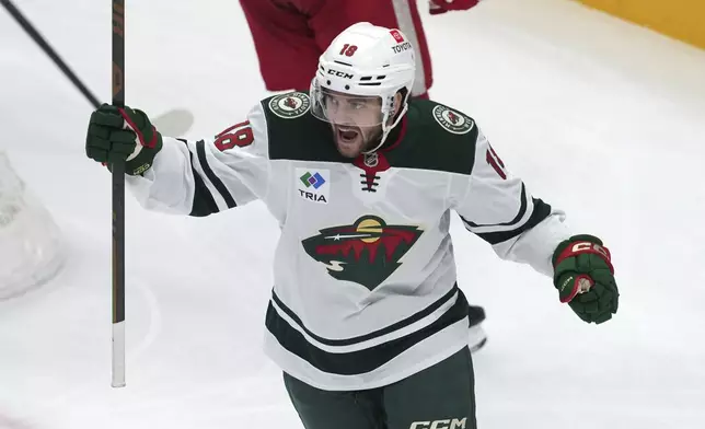 Minnesota Wild center Vinnie Hinostroza (18) celebrates his goal against the Detroit Red Wings in the second period of an NHL hockey game Saturday, Feb. 22, 2025, in Detroit. (AP Photo/Paul Sancya)