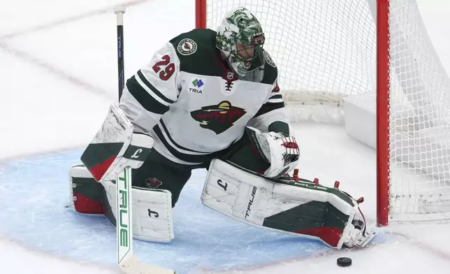 Minnesota Wild goaltender Marc-Andre Fleury (29) stops a shot against the Detroit Red Wings in the first period of an NHL hockey game Saturday, Feb. 22, 2025, in Detroit. (AP Photo/Paul Sancya)