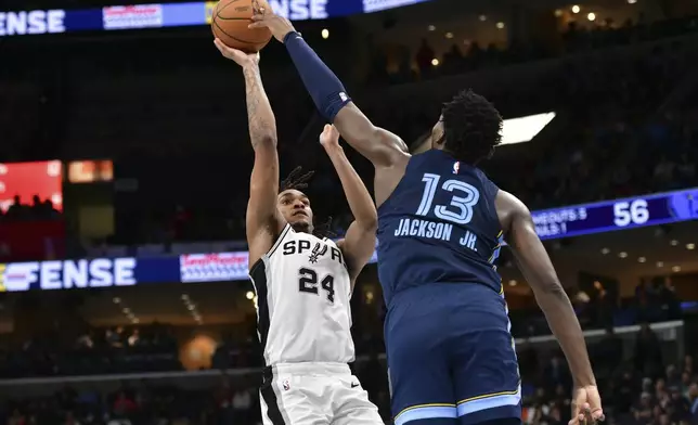 San Antonio Spurs guard Devin Vassell (24) shoots against Memphis Grizzlies forward Jaren Jackson Jr. (13) in the first half of an NBA basketball game Monday, Feb. 3, 2025, in Memphis, Tenn. (AP Photo/Brandon Dill)