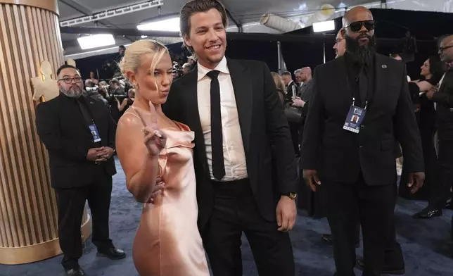 Millie Bobby Brown, left, and Jake Bongiovi arrive at the 31st annual Screen Actors Guild Awards on Sunday, Feb. 23, 2025, at the Shrine Auditorium in Los Angeles. (AP Photo/Chris Pizzello)