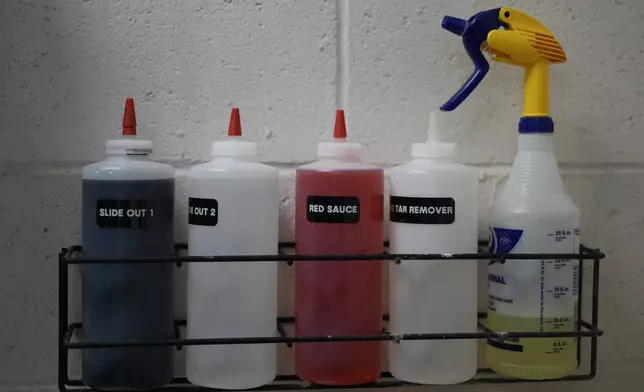 Solutions to clean a variety of stains and pine tar are stored above the San Francisco Giants laundry room sink during baseball spring training at the team's facility, Monday, Feb. 17, 2025, in Scottsdale, Ariz. (AP Photo/Carolyn Kaster)