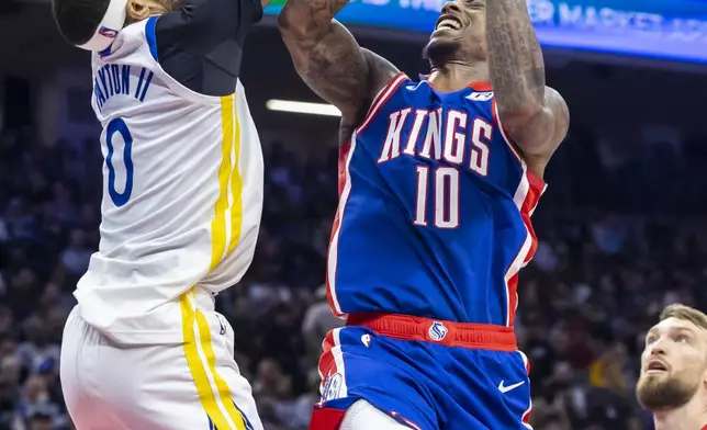 Sacramento Kings forward DeMar DeRozan (10) draws a foul on Golden State Warriors guard Gary Payton II (0) during the first half of an NBA basketball game Friday, Feb. 21, 2025, in Sacramento, Calif. (AP Photo/Sara Nevis)
