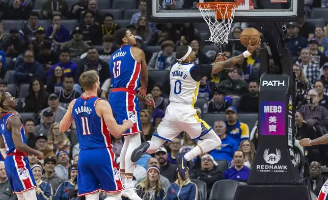 Golden State Warriors guard Gary Payton II (0) makes a reverse layup past Sacramento Kings forward Keegan Murray (13) during the first half of an NBA basketball game Friday, Feb. 21, 2025, in Sacramento, Calif. (AP Photo/Sara Nevis)