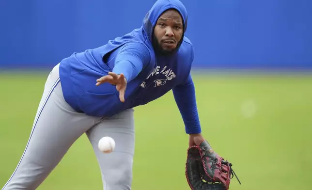 Toronto Blue Jays first baseman Vladimir Guerrero Jr. throws the ball to first base during spring training baseball workouts in Dunedin Fla., Thursday, Feb. 20, 2025. (Nathan Denette/The Canadian Press via AP)