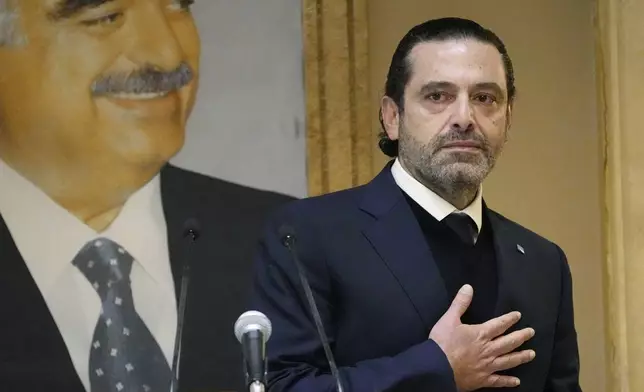 FILE - Former Lebanese Prime Minister Saad Hariri, gestures in front of a picture of his late father and former Prime Minister of Lebanon Rafic Hariri at his house in downtown Beirut, Lebanon, on Jan. 24, 2022. (AP Photo/Hussein Malla, File)
