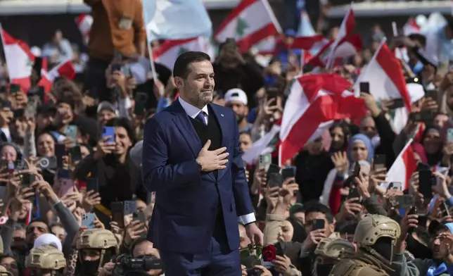 Former Lebanese Prime Minister Saad Hariri greets his supporters after he paid his respects at the grave of his father, former Prime Minister Rafik Hariri, on the 20th anniversary of his assassination in Beirut, Lebanon, Friday, Feb. 14, 2025. (AP Photo/Hassan Ammar)