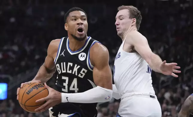 Milwaukee Bucks' Giannis Antetokounmpo tries to get past Memphis Grizzlies' Luke Kennard during the first half of an NBA basketball game Sunday, Feb. 2, 2025, in Milwaukee. (AP Photo/Morry Gash)