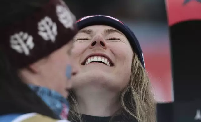 United States' Mikaela Shiffrin celebrates after winning the gold medal with teammate United States' Breezy Johnson, left, in a women's team combined event, at the Alpine Ski World Championships, in Saalbach-Hinterglemm, Austria, Tuesday, Feb. 11, 2025. (AP Photo/Marco Trovati)