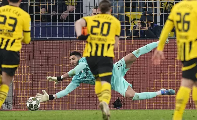 Sporting's goalkeeper Rui Silva saves the penalty kick during the Champions League playoff second leg soccer match between Borussia Dortmund and Sporting CP at the Signa-Iduna Park in Dortmund, Germany, Wednesday, Feb. 19, 2025. (AP Photo/Martin Meissner)