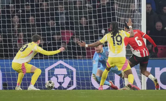 PSV's Ryan Flamingo, right, scores his side's third goal during the Champions League playoff second leg soccer match between PSV and Juventus at Phillips Stadium in Eindhoven, Netherlands, Wednesday, Feb.19, 2025. (AP Photo/Peter Dejong)