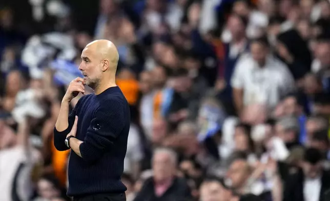 Manchester City's head coach Pep Guardiola watches the Champions League playoff second leg soccer match between Real Madrid and Manchester City at the Santiago Bernabeu Stadium in Madrid, Spain, Wednesday, Feb. 19, 2025. (AP Photo/Manu Fernandez)