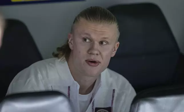 Manchester City's Erling Haaland sits on the bench ahead of the Champions League playoff second leg soccer match between Real Madrid and Manchester City at the Santiago Bernabeu Stadium in Madrid, Spain, Wednesday, Feb. 19, 2025. (AP Photo/Bernat Armangue)