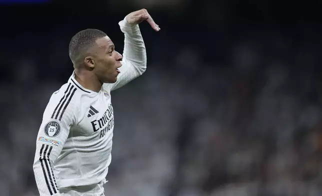 Real Madrid's Kylian Mbappe celebrates after scoring the opening goal of his team during the Champions League playoff second leg soccer match between Real Madrid and Manchester City at the Santiago Bernabeu Stadium in Madrid, Spain, Wednesday, Feb. 19, 2025. (AP Photo/Bernat Armangue)