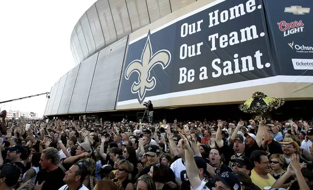 FILE - New Orleans Saints fans listen to the Goo Goo Dolls in front of the Louisiana Superdome in New Orleans, Sept. 25, 2006, upon reopening for the New Orleans Saints' first game in New Orleans since Hurricane Katrina struck more than a year earlier. (AP Photo/Alex Brandon, File)