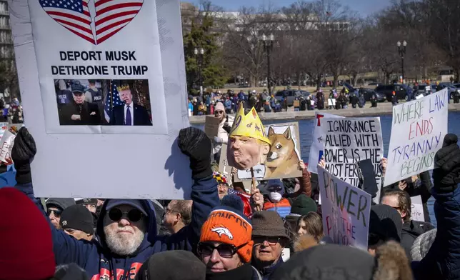 People take part in the "No Kings Day" protest on Presidents Day in Washington, in support of federal workers and against recent actions by President Donald Trump and Elon Musk, Monday, Feb. 17, 2025, at the reflecting pool by the Capitol in Washington. The protest was organized by the 50501 Movement, which stands for 50 Protests 50 States 1 Movement. (AP Photo/Jacquelyn Martin)