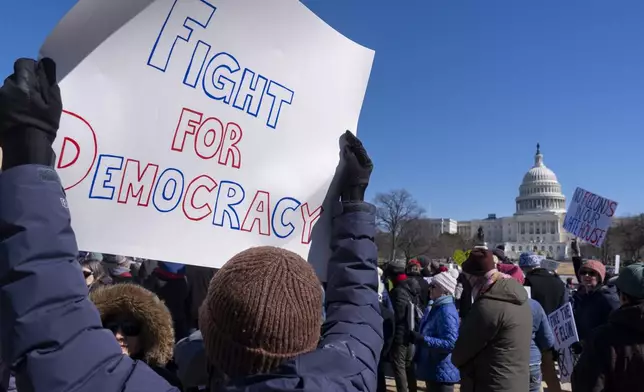 People protest as part of the “No Kings Day” protest on Presidents Day in Washington, in support of federal workers and against recent actions by President Donald Trump and Elon Musk, Monday, Feb. 17, 2025, by the Capitol in Washington. The protest was organized by the 50501 Movement, which stands for 50 Protests 50 States 1 Movement. (AP Photo/Jacquelyn Martin)